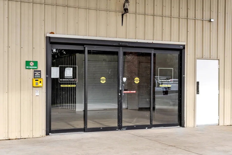 Secure indoor storage entrance with sliding glass doors and keypad access system